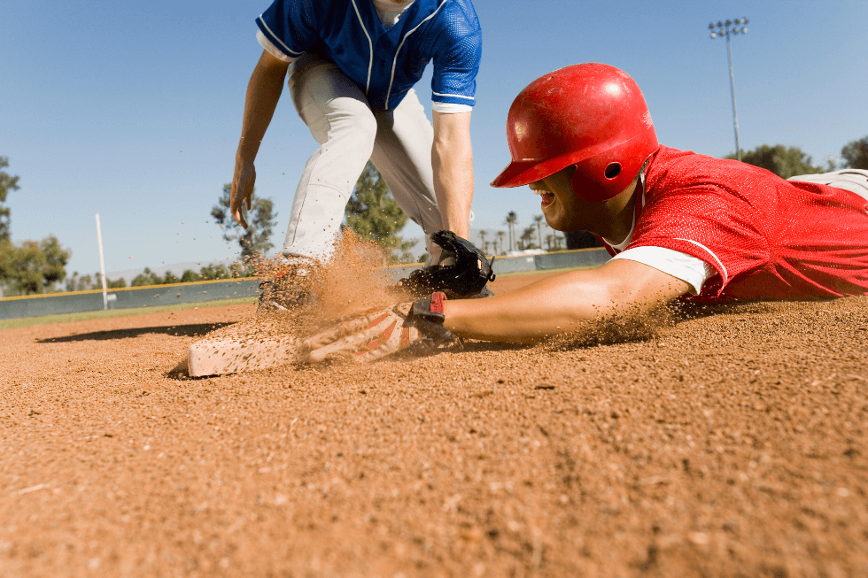 Baseball player sliding into base