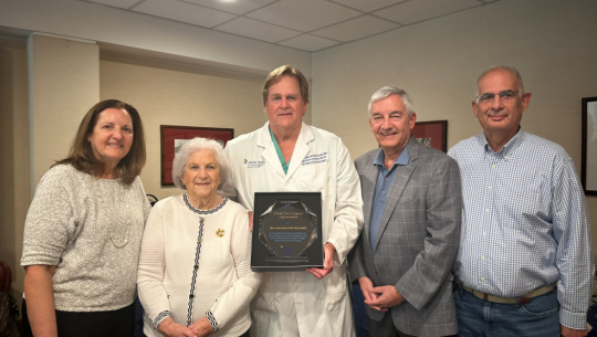 Janet Kroll (second from left) and family are honored by Edward Lundy, MD (third from left), Surgical Director of the Kroll Family Center for Heart Failure and Circulatory Support, on the 10th anniversary of the center being established with the family’s support at St. Francis Hospital. 