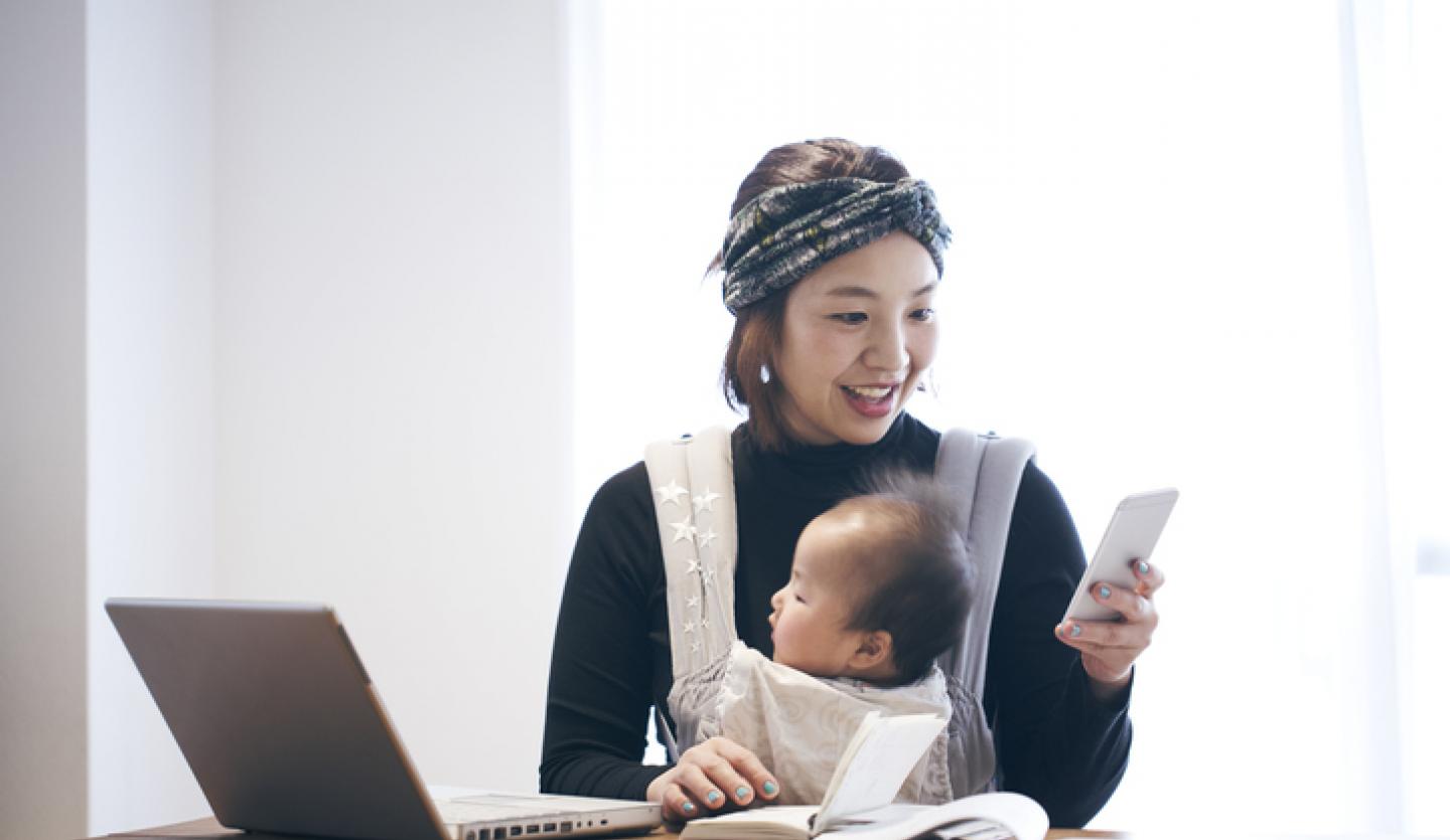 mother with baby looking at phone