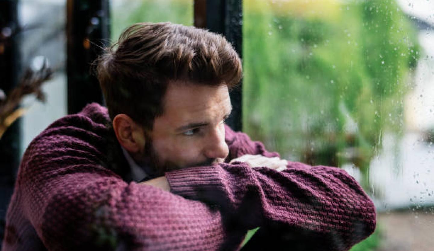 Sad man at window