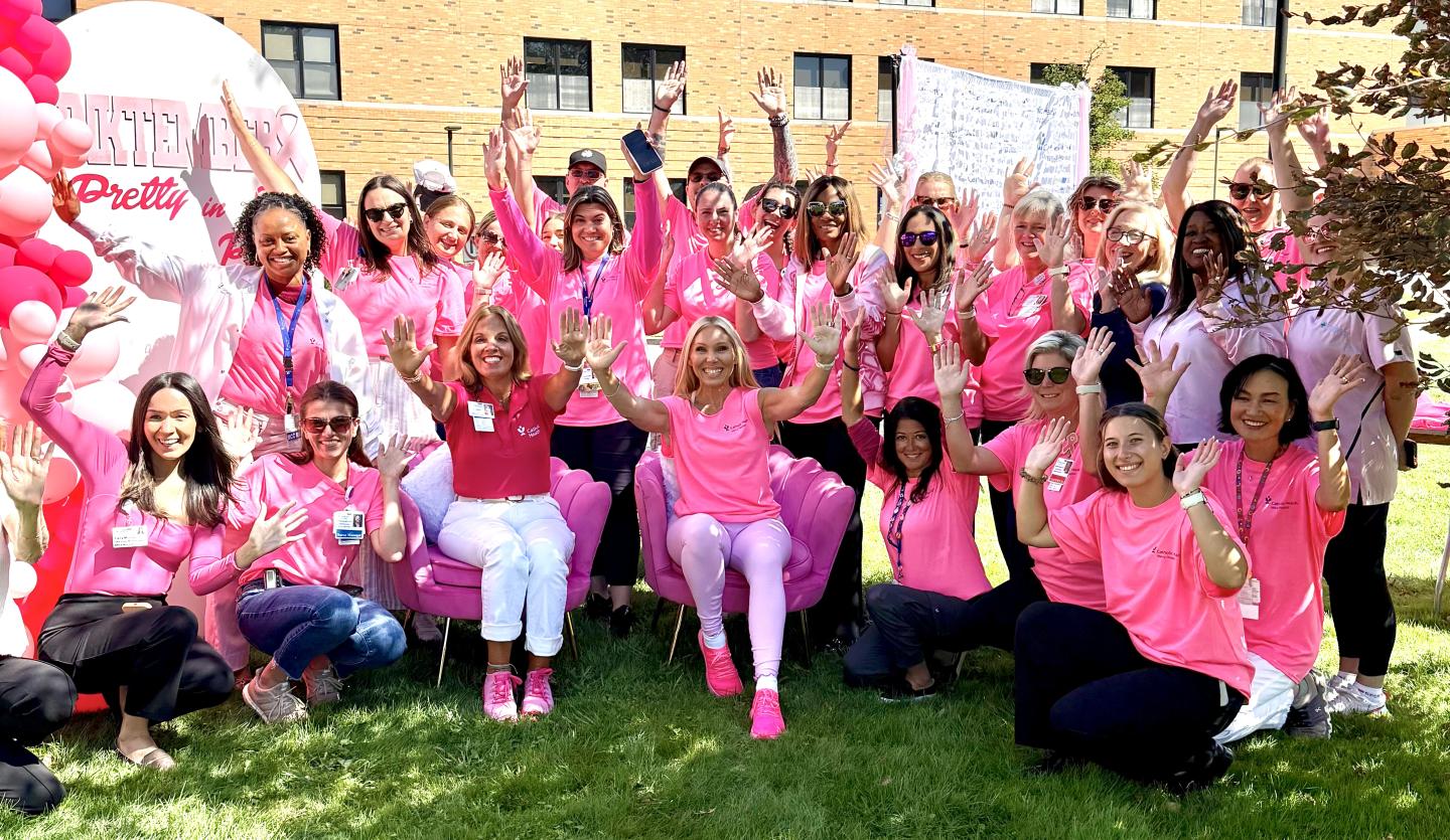 Group of women in pink celebrate