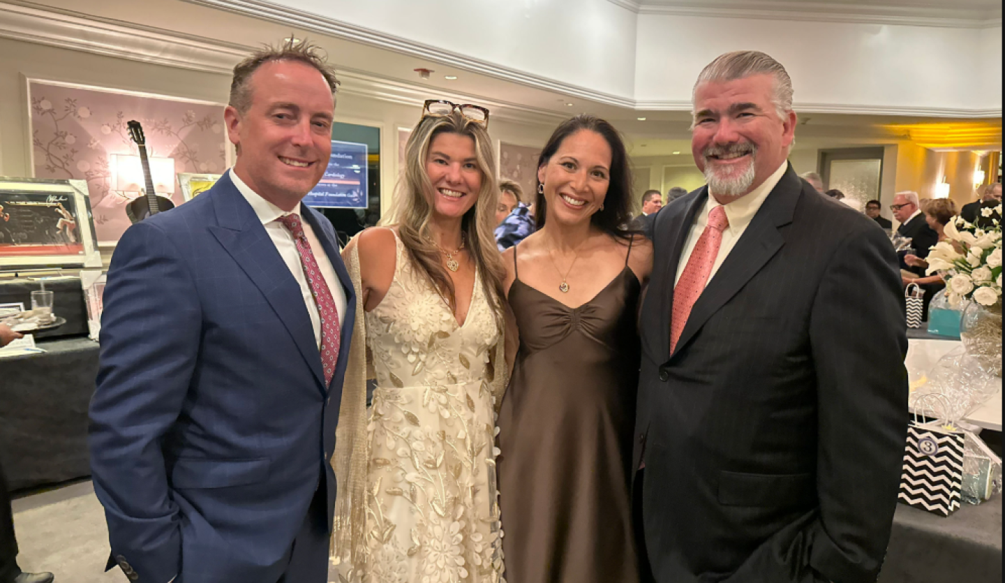 4 members of the Bahnik family stand in a line together at an event