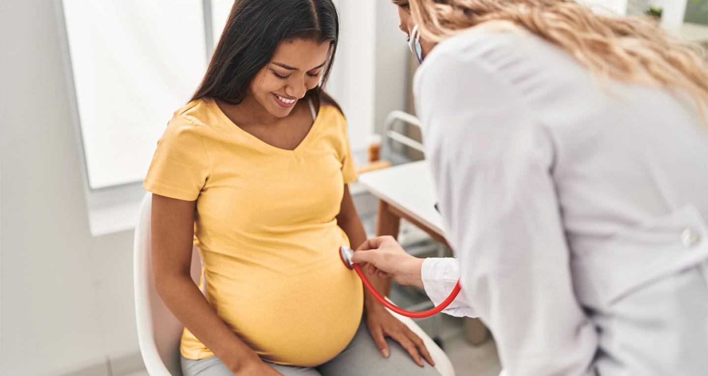 Pregnant woman being examined by doctor