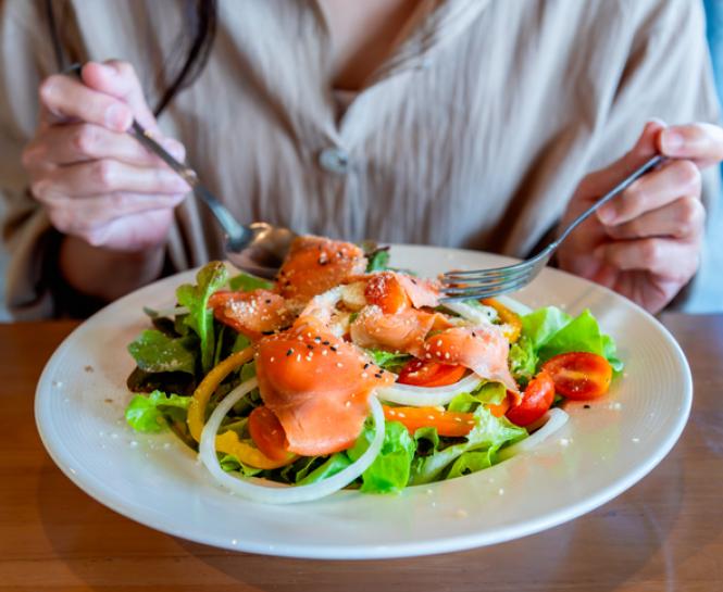 person eating salmon salad