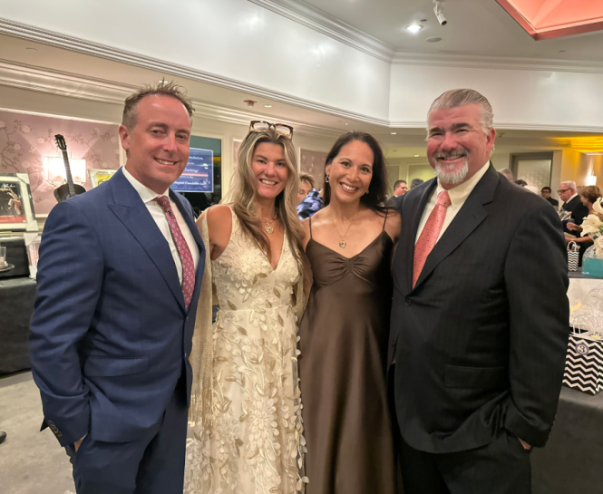 4 members of the Bahnik family stand in a line together at an event