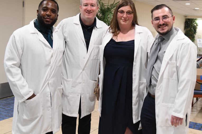 4 students in white lab coats at the Mercy Hospital School of Radiology Graduation