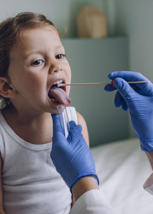 doctor checking child's throat
