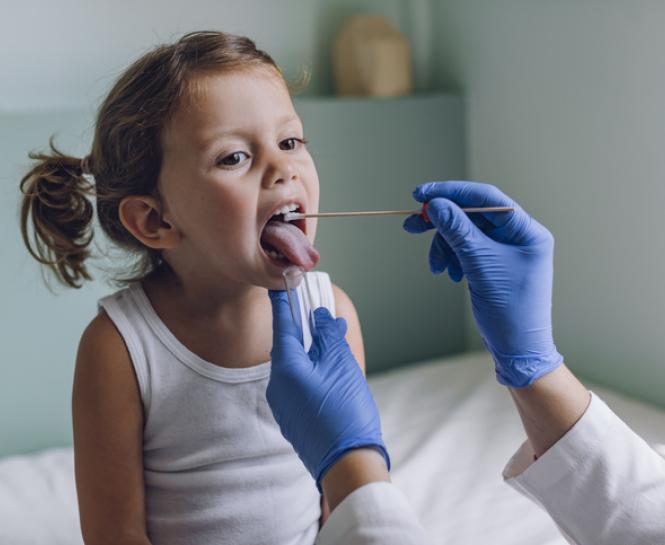 doctor checking child's throat