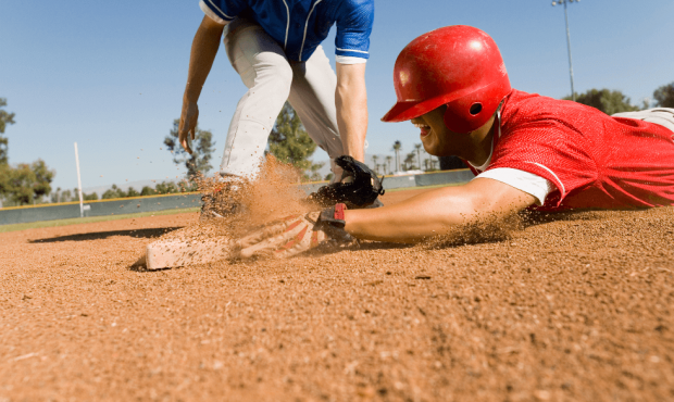 Baseball player sliding into base